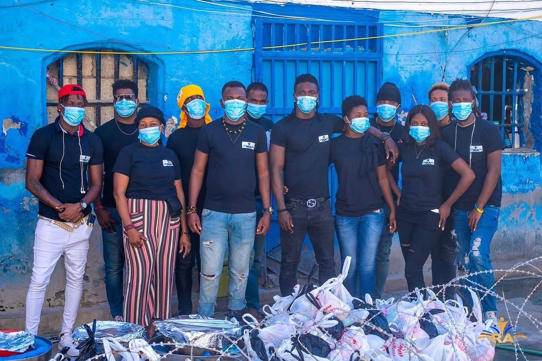Foundation team standing with bags of supplies for community distribution